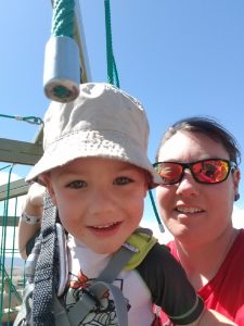 A close up of a mother and son having a zipline and family whitewater rafting adventure in Colorado