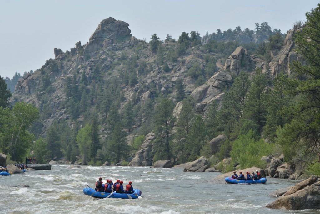 A far away picture of a group engaged in Browns Canyon rafting