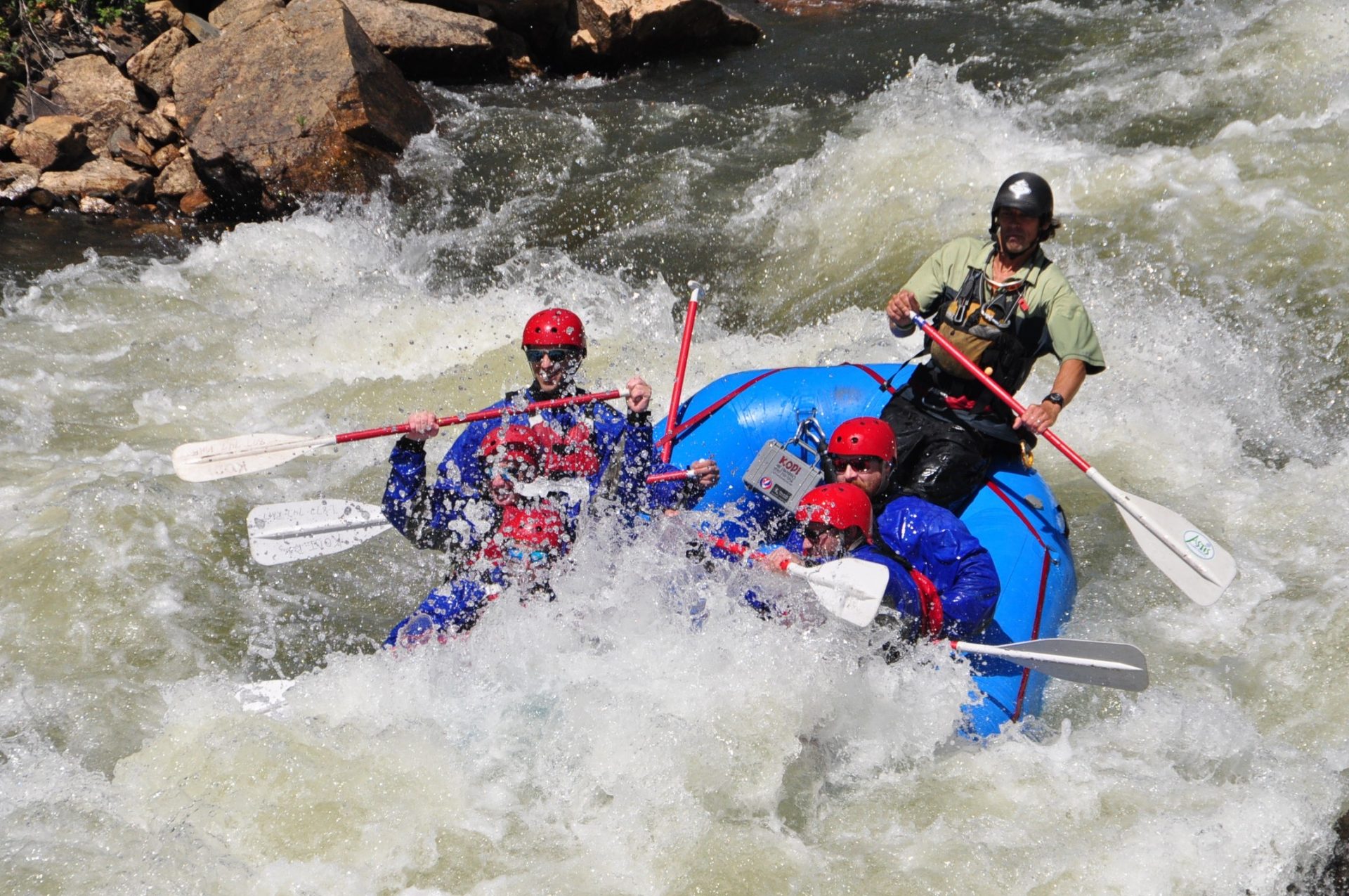Tourists enjoy themselves while advanced whitewater rafting
