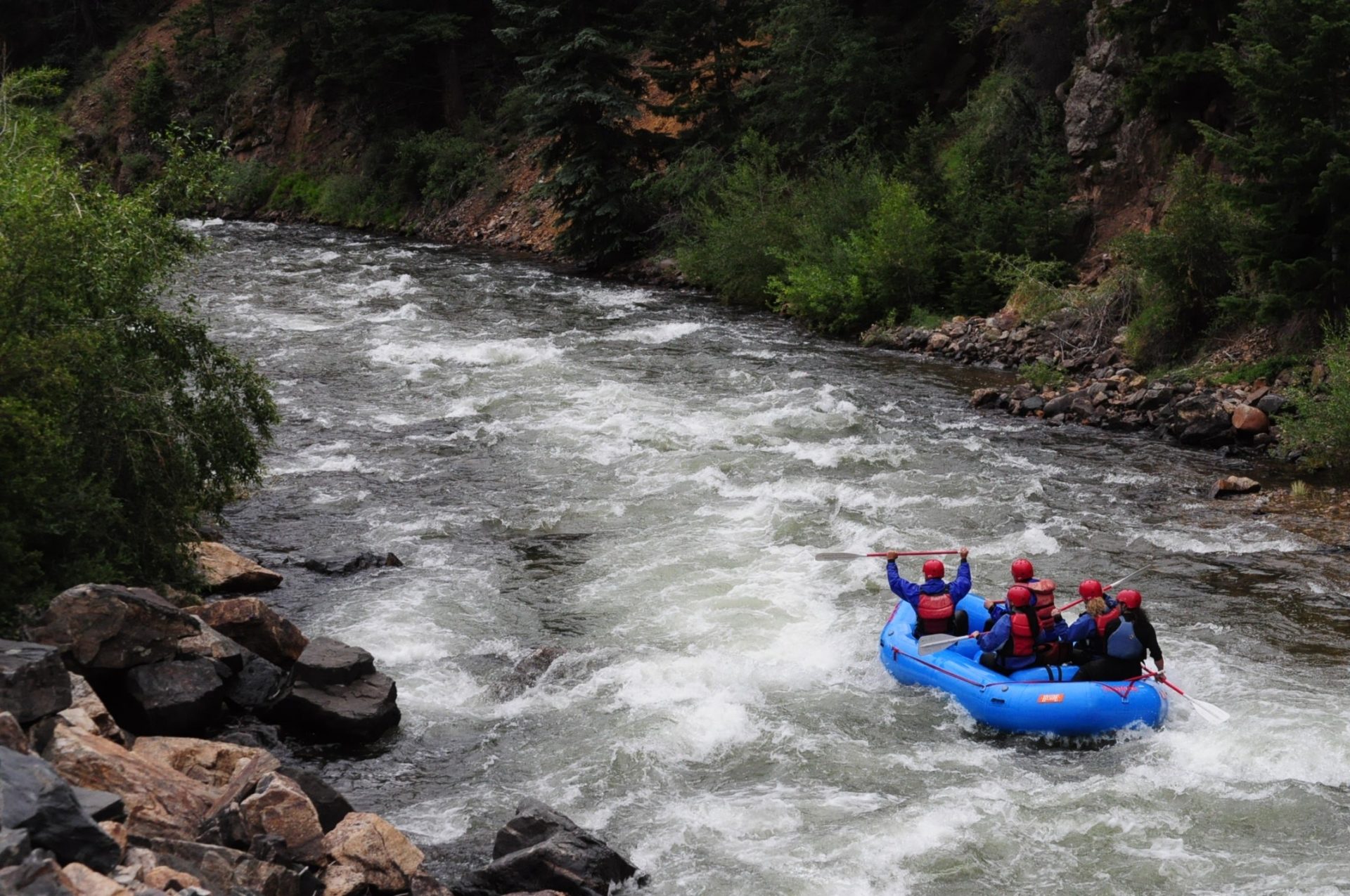 Tourist group having fun while Clear Creek rafting in Colorado