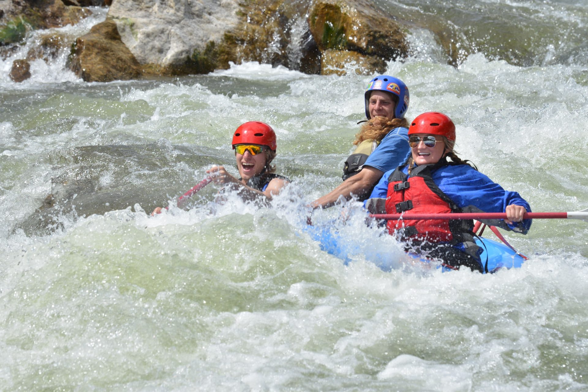 Tourists going through rapids while whitewater rafting Arkansas