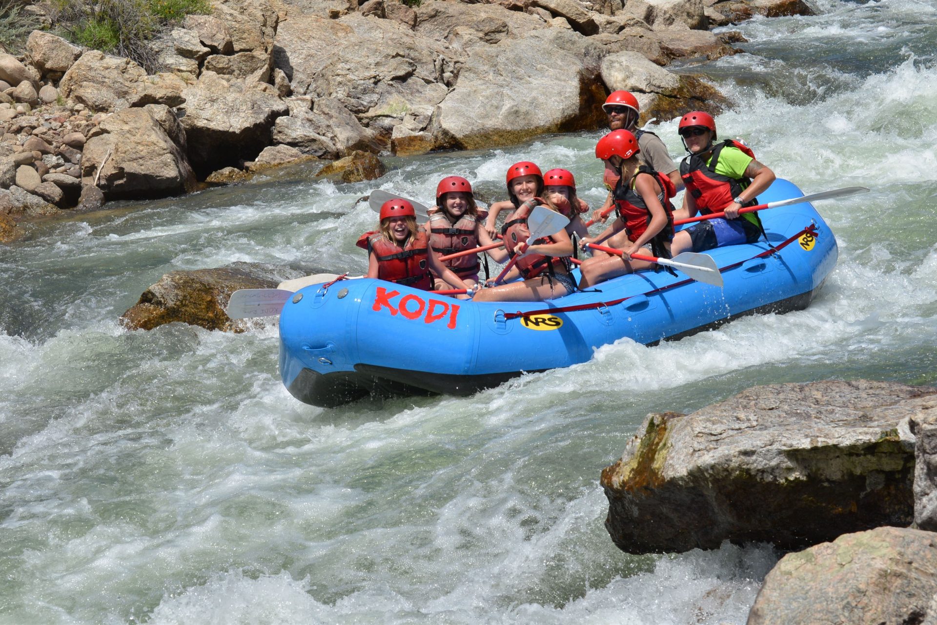 A tourist group engaged in a thrilling kayaking experience on the river