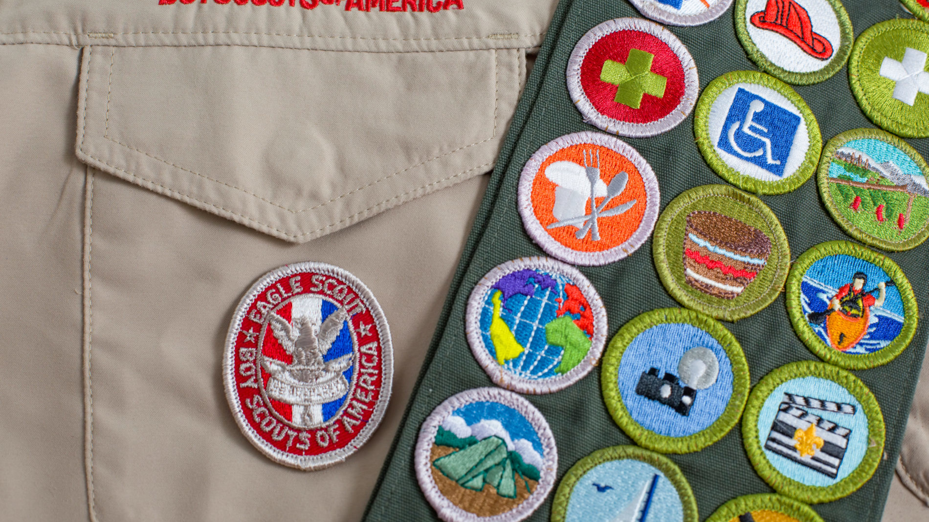Boy scout jacket with many merit badges, including a Kayaking badge for beginner whitewater kayaking