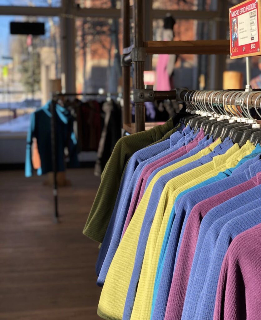 Hangers with specially made yellow, blue, maroon, and green shirts