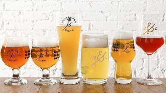 Different beer glassware with diverse beers placed on a table for drinks after whitewater adventures
