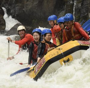 A rafting team taking on class 5 whitewater rafting waves of Arkansas river rafting adventures