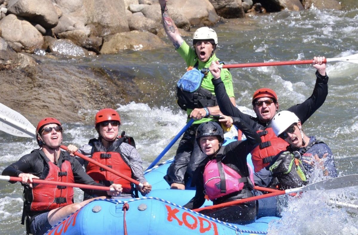 A rafting group cheering during a class 3 whitewater rafting adventure on Colorado river rapids