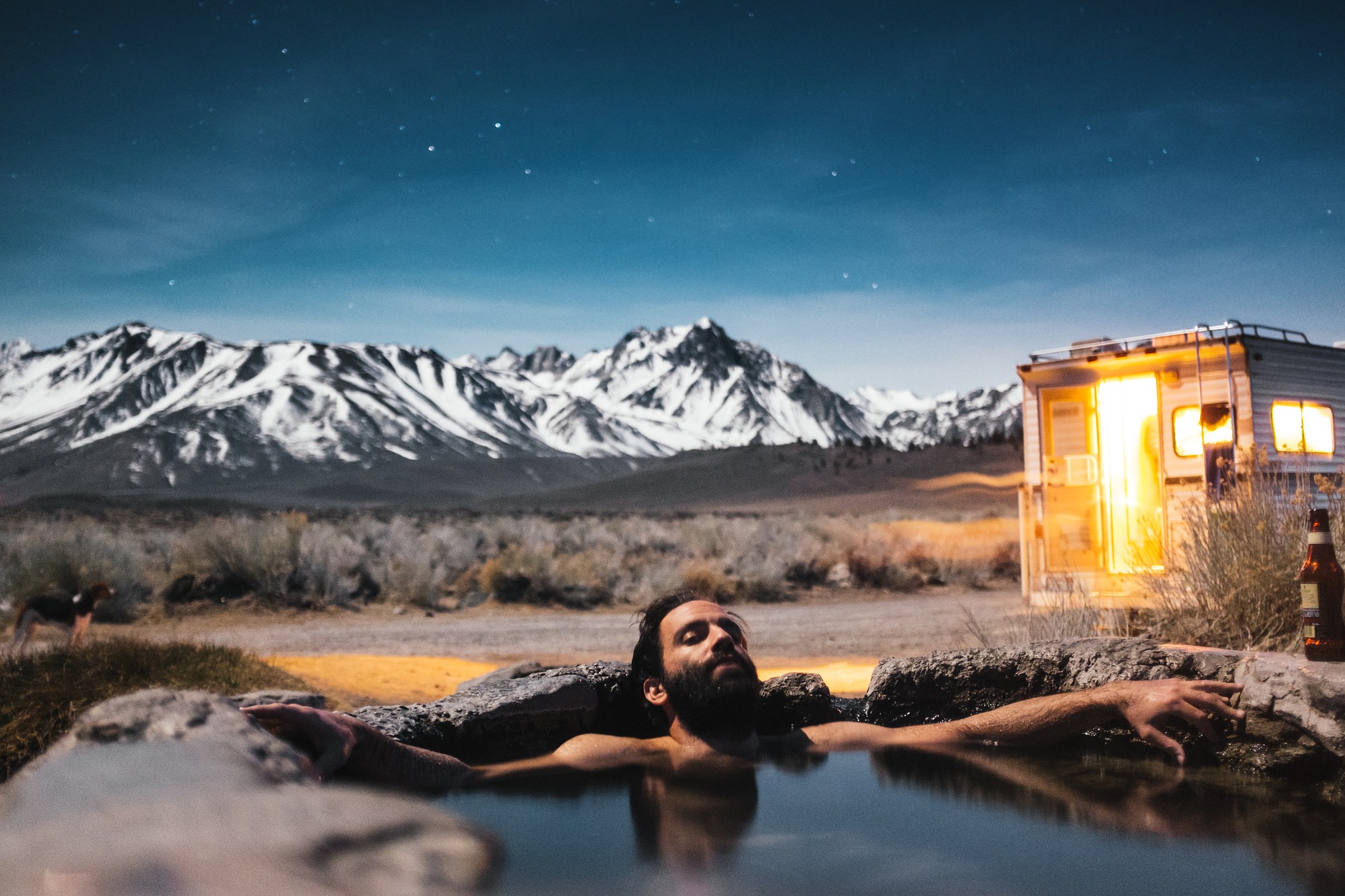 Man in a hot spring bath, outdoors; after Arkansas river rafting